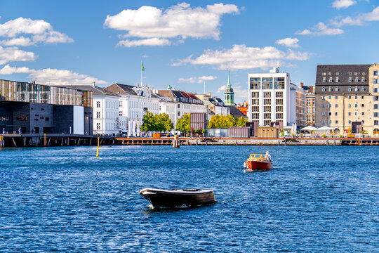 Boats floating on a water canal in Copenhagen with a view of Nyhavn, Scandinavia.