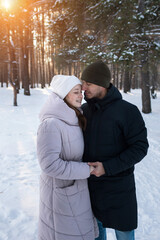 Lovers Sharing Warm Feelings Amidst Snowy Woods, An Affectionate Pair Exchanging Heat Beneath Icy Woodland Canopy, Two Individuals Found Comfort Together Within Cold And Snowy Forest Landscape