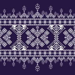 Moody lifestyle portrait of a young woman wearing a casual cap and modern outfit, sitting indoors with soft dramatic lighting. Contemporary fashion and relaxed lifestyle concept with artistic interior