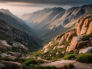 Majestic mountain valley with rocky terrain and soft evening light  