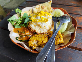 Nasi pecel or sego pecel is a typical Javanese Indonesian rice dish served with pecel sauce,...
