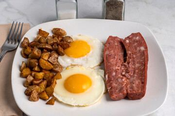 fried eggs  with  home fries and smoked sausage