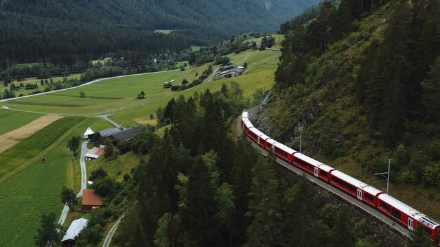 Drone Tracking Shot of Glacier Express Train Through Swiss Alps in Summer