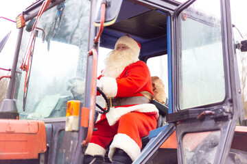 Authentic Santa Claus in a red tractor. Delivery of gifts to hard-to-reach regions.