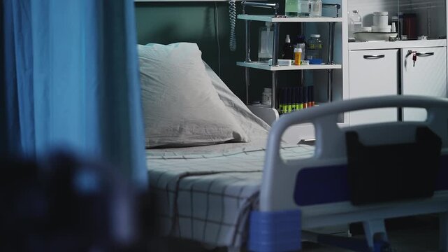 Modern ICU hospital room with empty bed and medication bottles on shelves