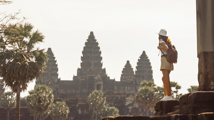 Backpacker At Angkor Wat Temple At Sunrise, Cambodia Travel Inspiration © Buyanskyy Production