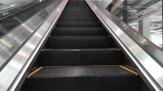 Moving escalator going up in modern mall
