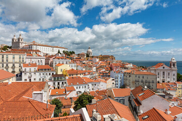 Wide panoramic view of Lisbon featuring the National Pantheon and Monastery of S&atilde;o Vicente de Fora with the Tagus River in the background.