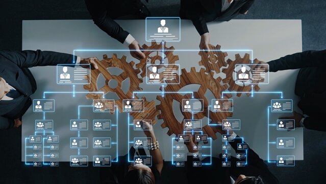 A dynamic business meeting scene showcasing teamwork and strategy development with wooden gears and digital data overlays in a modern office environment. Raster - Powered by Adobe