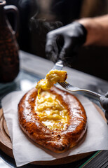 Georgian khachapuri being eaten with fork
