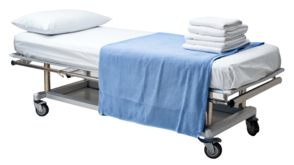 Hospital bed with clean linens and fresh towels, ready for patient use in a medical setting, isolated on a white background.