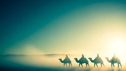 Caravan of camels walking in the desert at sunrise with foggy landscape background