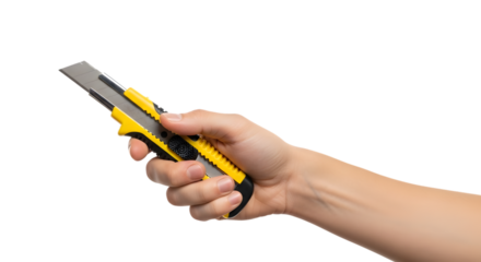 Hand holding a yellow and silver utility knife isolated on transparent background