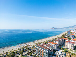 Striking High-Angle Aerial View of a Long, Sandy Beach and Turquoise Mediterranean Sea Bordering the Alanya Cityline on a Clear Day