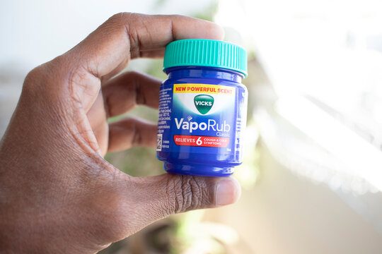 Vicks VapoRub Bottle holding in hand Close Up - 20 December 2025 : Junagadh, Gujarat, India