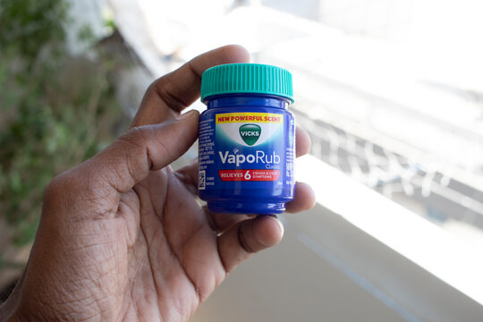 Vicks VapoRub Bottle holding in hand Close Up - 20 December 2025 : Junagadh, Gujarat, India