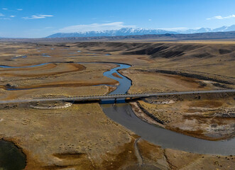 a bridge over a river in a valley