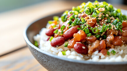 A delicious bowl of rice topped with savory beans, fresh herbs, and sesame seeds, perfect for a healthy meal.