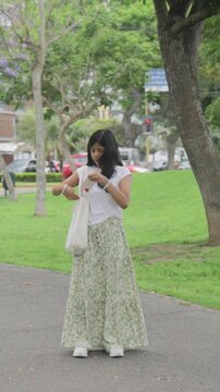 Teen Girl Using Phone for Directions and Turning Around