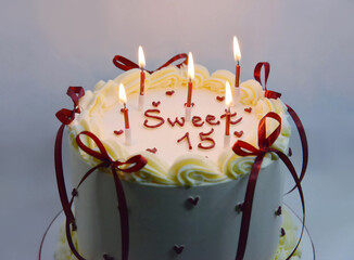 Sweet Fifteen Birthday Cake with Candles and Cream Decoration
