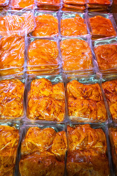 Slices of meats are for sale in the supermarket's refrigerated display.