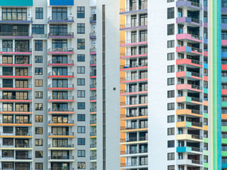 Fototapeta premium Colorful Apartment Building Facade with Repeating Balconies