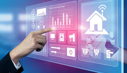 A close-up view of a hand interacting with a futuristic touchscreen interface that displays various smart home features and energy usage data for modern living. Gantry