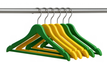Green and yellow wooden clothes hangers hanging on metal rail, organized for retail display or closet storage, transparent background