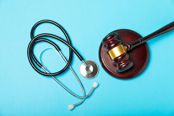 A stethoscope and hammer on a desk. Medical malpractice, personal injury lawyer, and healthcare...