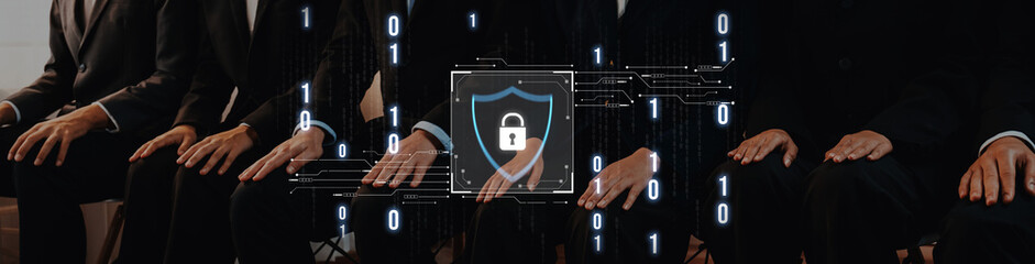 Business professionals in suits are seated together, symbolizing teamwork and collaboration while...