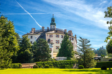 Historic Ambras Castle Under a Bright Blue Sky with Lush Green Gardens © EdVal