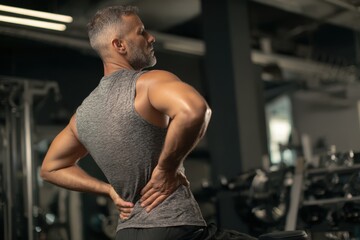 man with back pain in the gym