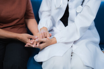 Doctor holding patient's hands offering comfort and support
