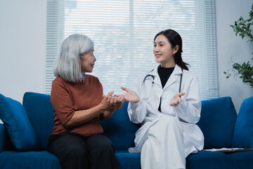Fototapeta premium Doctor discussing health with senior patient at home