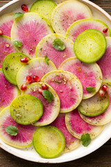 Close  up of sliced winter pink radishes on plate food texture