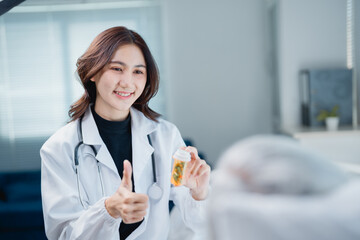 Female doctor explaining prescription to patient with thumbs up