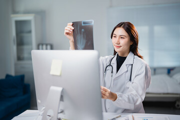 Female doctor analyzing x-ray during telemedicine consultation