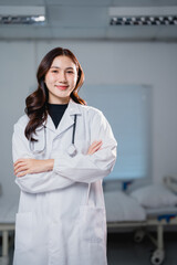 Asian female doctor standing with arms crossed in hospital