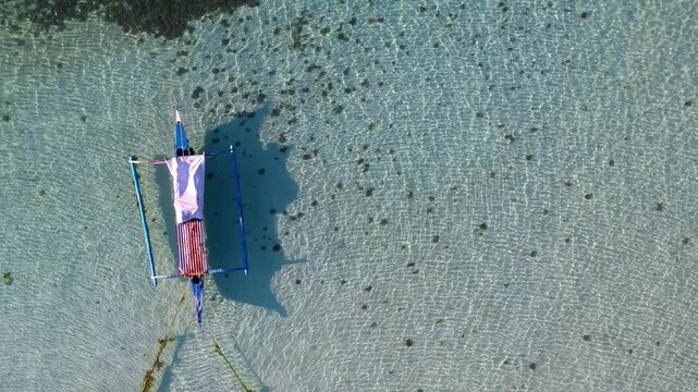 Top-down aerial view of tropical water and boat