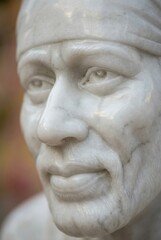 Fototapeta premium Close-up Marble Sculpture of Sai Baba's Serene Face