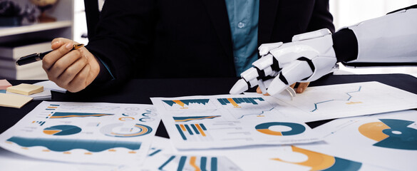 A business professional engages in data analysis using a robotic hand, showcasing various charts...