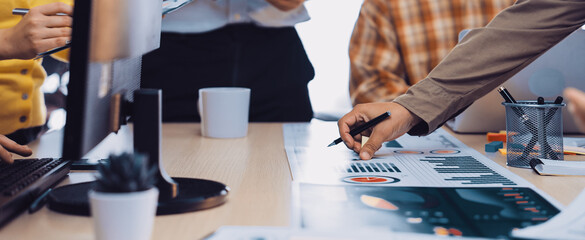 A diverse team engages in a dynamic meeting, analyzing data and developing strategies. The collaborative atmosphere showcases modern office tools and effective communication. SACTR