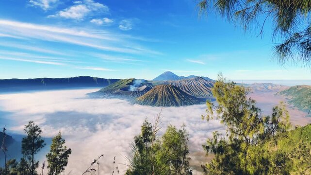 Eruption of the Bromo volcano during sunrise in the Bromo-Tengger-Semeru National Park, East Java, Indonesia. The Tengger volcanic caldera is in cloud and fog. Dawn. 4К
