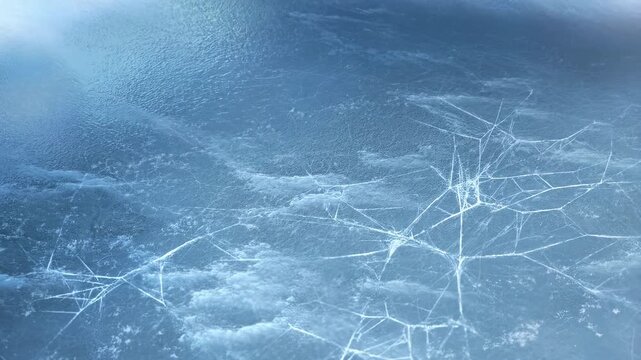 Cracking ice surface expanding with subtle fractures in cold winter environment