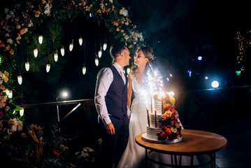 newlyweds happily cut and taste the wedding cake