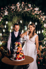 newlyweds happily cut and taste the wedding cake