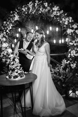 newlyweds happily cut and taste the wedding cake