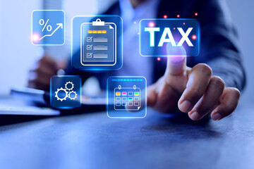 Tax concept with businessman pointing on virtual interface to calculate to pay annual taxation based on incoming earning in year