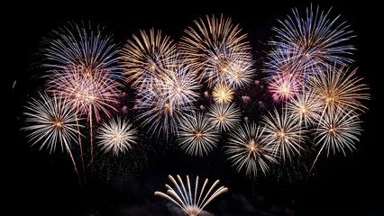 Spectacular burst of multiple colorful fireworks against a dark night sky for celebration