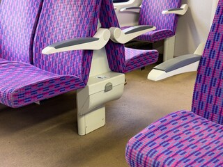 Interior of modern czech train with colourful seats and bin